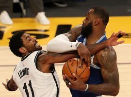 Kyrie Irving of the Brooklyn Nets defends LeBron James from the LA Lakers. (Image: Katelyn Mulcahy/Getty)