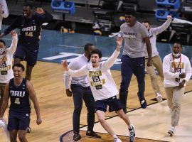 The Oral Roberts Golden Eagles celebrate a major upset as a #15 seed with a victory over #7 Florida in the second round of March Madness. (Image: Doug McSchooler/USA Today Sports)