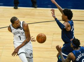Kevin Durant of the Brooklyn Nets dishes a behind-the-back pass against the Minnesota Timberwolves. (Image: Craig Lassig/AP)
