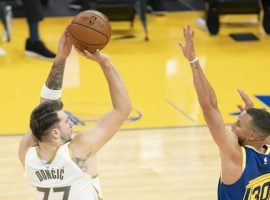 Luka Doncic of the Dallas Mavericks shoots over Steph Curry from the Golden State Warriors during a 30-point thumping. (Image: Kyle Terada/USA Today Sports)