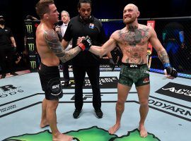 Dustin Poirier (left) and Conor McGregor (right) will meet up for a third time when the two fight at UFC 264 in Las Vegas this summer. (Image: Jeff Bottari/Zuffa/Getty)