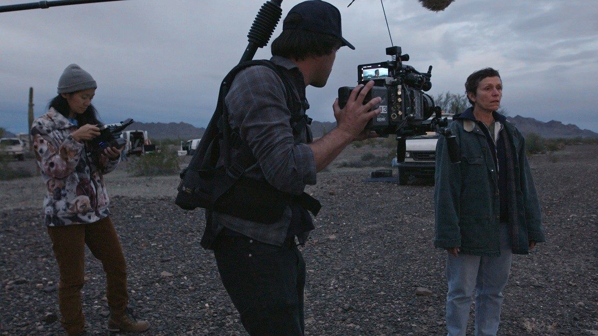 Director Chloe Zhao (left), seen here on set of Nomadland with France McDermott, is the favorite to win multiple categories at the 2021 Oscars. (Image: Fox Searchlight Pictures)