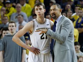 Michigan’s Franz Wagner attentively listens to advice from head coach Juwan Howard during a game against Indiana in 2020. (Image: Rick Osentoski/USA Today Sports)