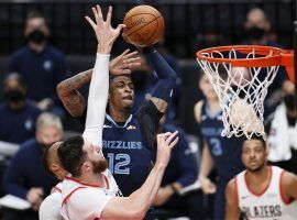 Ja Morant of the Memphis Grizzlies elevates for a dunk over Jusuf Nurkic of the Portland Trail Blazers in a recent game at the Moda Center in Portland, Oregon. (Image: Steph Chambers/Getty)