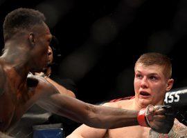 Israel Adesanya (left) will try to score a second win over Marvin Vettori (right) and defend his middleweight title in the main event of UFC 263. (Image: Getty)