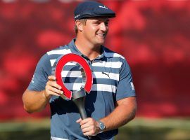Bryson DeChambeau poses after winning the 2020 Rocket Mortgage Classic. He’ll look to repeat as champion at Detroit Golf Club this weekend. (Image: Carlos Osorio/AP)