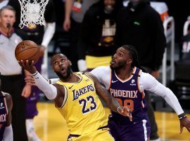 LeBron James of the Los Angeles Lakers scoops a layup under Jae Crowder of the Phoenix Suns during Game 3 at Staples Center in downtown LA. (Image: Sean M. Haffey/Getty)