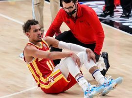 Trae Young of the Atlanta Hawks sits on the court after suffering an ankle injury when he tripped into an official in Game 3 of the Eastern Conference Finals against the Milwaukee Bucks. (Image: USA Today Sports)