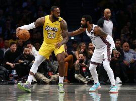 LeBron James from the LA Lakers is guarded by Kyrie Irving from the Brooklyn Nets. Both the Lakers and Nets have the best opening odds to win the NBA championship next year. (Image: Mike Stobe/Getty)