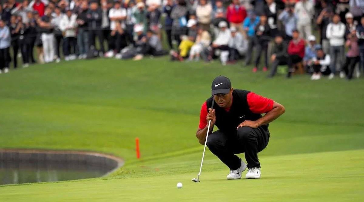 Tiger Woods lines up his shot with his favorite putter.