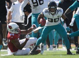 Kick returner Jamal Agnew from the Jacksonville Jaguars evades a tackle from the Arizona Cardinals during a record-setting touchdown. (Image: Phelan M. Ebenhack/AP)