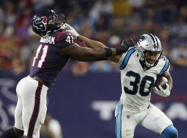 Rookie running back Chuba Hubbard from the Carolina Panthers stiff arms a defender from the Houston Texans in Week 3. (Image: Getty)