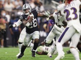 Raiders running back Josh Jacobs evades tacklers from the Baltimore Ravens during a Monday Night Football Game at Allegiant Stadium in Las Vegas. (Image: Getty)