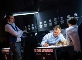 Ian Nepomniachtchi (left) watches Magnus Carlsen (center) play Aryan Tari (right) in the second round of Norway Chess. Nepomniachtchi and Carlsen will face off for the World Chess Championship later this year. (Image: Lennart Ootes/Norway Chess)