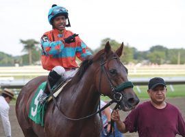 Jockey Tomas Mejia was suspended for 10 years after a photo revealed he had a prohibited electronic device in his hand during a Sept. 3 allowance at Monmouth Park. (Image: Equi-Photo)