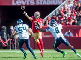 Rookie quarterback Trey Lance from the San Francisco 49ers evades a pair of Seattle Seahawks defenders after replacing Jimmy G, who went down with an injury. (Image: Getty)