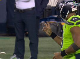Seattle Seahawk quarterback Russell Wilson tries to flex his hand after his dislocated his middle finger against the LA Rams. (Image: NFL Network)