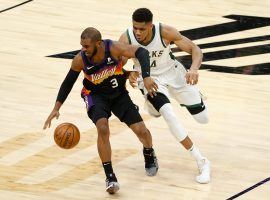 Chris Paul of the Phoenix Suns dribbles away from Giannis Antetokounmpo from the Milwaukee Bucks during the 2021 NBA Finals. (Image: Christian Peterson/Getty)