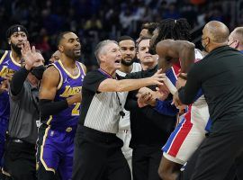 Detroit Pistons coaches and an NBA official attempt to hold back Isaiah Stewart after LeBron James from the Lakers caught him with an elbow to the face. (Image: Carlos Osorio/AP)