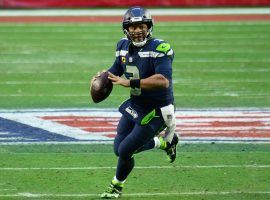 Seattle Seahawks quarterback Russell Wilson rolls out of the pocket against the San Francisco 49ers. (Image: USA Today Sports)