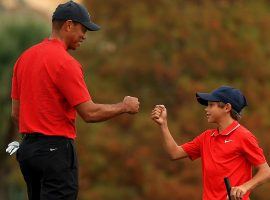 Tiger Woods (left) will return to action next week when he plays with his son Charlie (right) at the PNC Championship. (Image: Getty)
