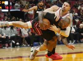 Chicago Bulls center Nickola Vucevic wraps up PJ Tucker from the Miami Heat at American Airlines Arena in Miami. (Image: Marta Lavandier/AP)