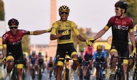 Egan Bernal, flanked by teammates from Ineos Grenadiers, enters Paris in 2019 en route to his first victory at the Tour de France. (Image: Anne-Christine Pouhoulat/Getty)