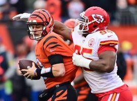 Joe Burrow from the Cincinnati Bengals tries to evade a sack from Chris Jones of the Kansas City Chiefs during a Week 17 matchup. (Image: Getty)