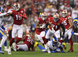 San Francisco 49ers RB Elijah Mitchell bursts through the defensive line of the LA Rams at Levi Stadium in Santa Clara, CA. (Image: Ezra Shaw/Getty)