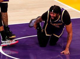 Anthony Davis from the LA Lakers clutches his sprained ankle after he suffered an injury on a freak play against the Utah Jazz at Crypto.com Arena. (Image: Getty)