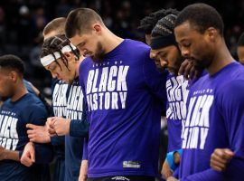 Alex Len (center) is surrounded by players from the Sacramento Kings and Denver Nuggets during a moment of silence before their game to pay respect to Len's home country of Ukraine. (Image: Getty)