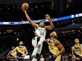 Giannis 'Greek Freak' Antetokounmpo from the Milwaukee Bucks drives the lane to score two of his game-high 50 points against Buddy Hield (24) and the Indiana Pacers. (Image: Getty)