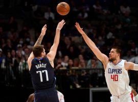 A red-hot Luka Doncic from the Dallas Mavs shoots a 3-pointer over Ivan Zubac from the LA Clippers. (Image: Glenn James/Getty)