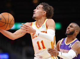 Trae Young from the Atlanta Hawks drives by Chris Paul of the Phoenix Suns to score two of his game-high 43 points. (Image: Michael Howser/Getty)