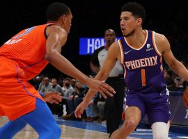 Devin Booker from the Phoenix Suns is defended by Darius Bazley from the Oklahoma City Thunder. (Image: Sue Ogrocki/AP)