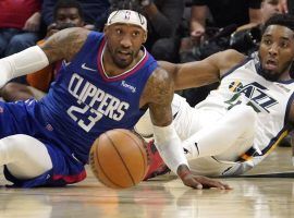 Robert Covington (23) from the LA Clippers and Donovan Mitchell of the Utah Jazz dive for a loose ball. (Image: Mark J. Terrill/AP)