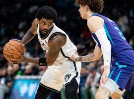 Kyrie Irving from the Brooklyn Nets is hand-checked by LaMelo Ball of the Charlotte Hornets, but that did not slow down Kyrie from scoring a season-high 50 points. (Image: Getty)
