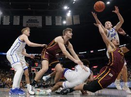 Garrett Sturtz (3) from Drake attempts to grab a loose ball from Lucas Williamson (1) Â from the Loyola Chicago Ramblers in the Missouri Valley Conference finals of their conference tournament. (Image: Jeff Roberson/AP)