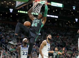 Boston Celtics center Robert Williams III throws down a dunk against the Minnesota Timberwolves on Sunday before he suffered a knee injury that could derail the Celtics title chances. (Image: Getty)