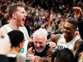 Members of the San Antonio Spurs mob head coach Gregg 'Pops' Popovich after he set the new NBA record for most wins as a head coach. (Image: Getty)