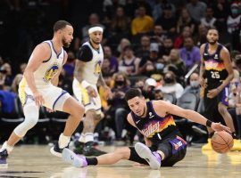 Devin Booker from the Phoenix Suns slipped against the Steph Curry and the Golden State Warriors during a Christmas game. (Image: Joe Camporeale/USA Today Sports)