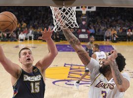 Nikola Jokic from the Denver Nuggets drives for a layup against Anthony Davis from the LA Lakers at Crypto.com Arena. (Image: Mark J. Terrill/AP)