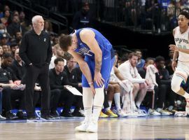 Luka Doncic from the Dallas Mavs clutches his left calf after he suffered an injury against the San Antonio Spurs in the final game of the regular season. (Image: USA Today Sports)