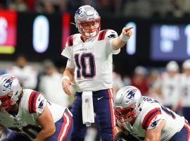 Mac Jones (10) from the New England Patriots calls an audible against the Atlanta Falcons last season. (Image: Todd Kirkland/Getty)