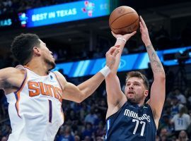 Luka Doncic from the Dallas Mavs shoots a jumper over Devin Booker of the Phoenix Suns in Game 6 at the American Airlines Center. (Image: Getty)