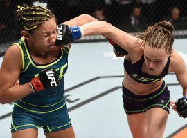 Rose Namajunas (right) and Carla Esparza (left) will fight for the strawweight title on Saturday night in a rematch nearly eight years in the making. (Image: Zuffa/Getty)