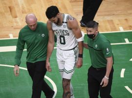 Boston Celtics trainers help Jayson Tatum off the court in Game 3 against the Miami Jeat when he suffered a neck injury, but he’s expected to play in Game 4. (Image: Getty)