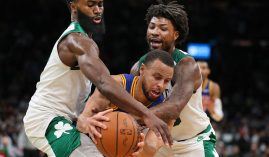 Steph Curry from the Golden State Warriors gets harassed by Jaylen Brown and Marcus Smart of the Boston Celtics. (Image: Getty)