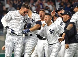 The New York Yankees mob Aaron Judge (far left) at home plate after he hit a walk-off home run to defeat the Toronto Blue Jays 6-5 at Yankee Stadium. (Image: Getty)