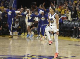Jordan Poole from the Golden State Warriors celebrates drilling a half-court 3-point shot to end the third quarter of Game 2 of the NBA Finals at Chase Center in San Francisco. (Image: Getty)